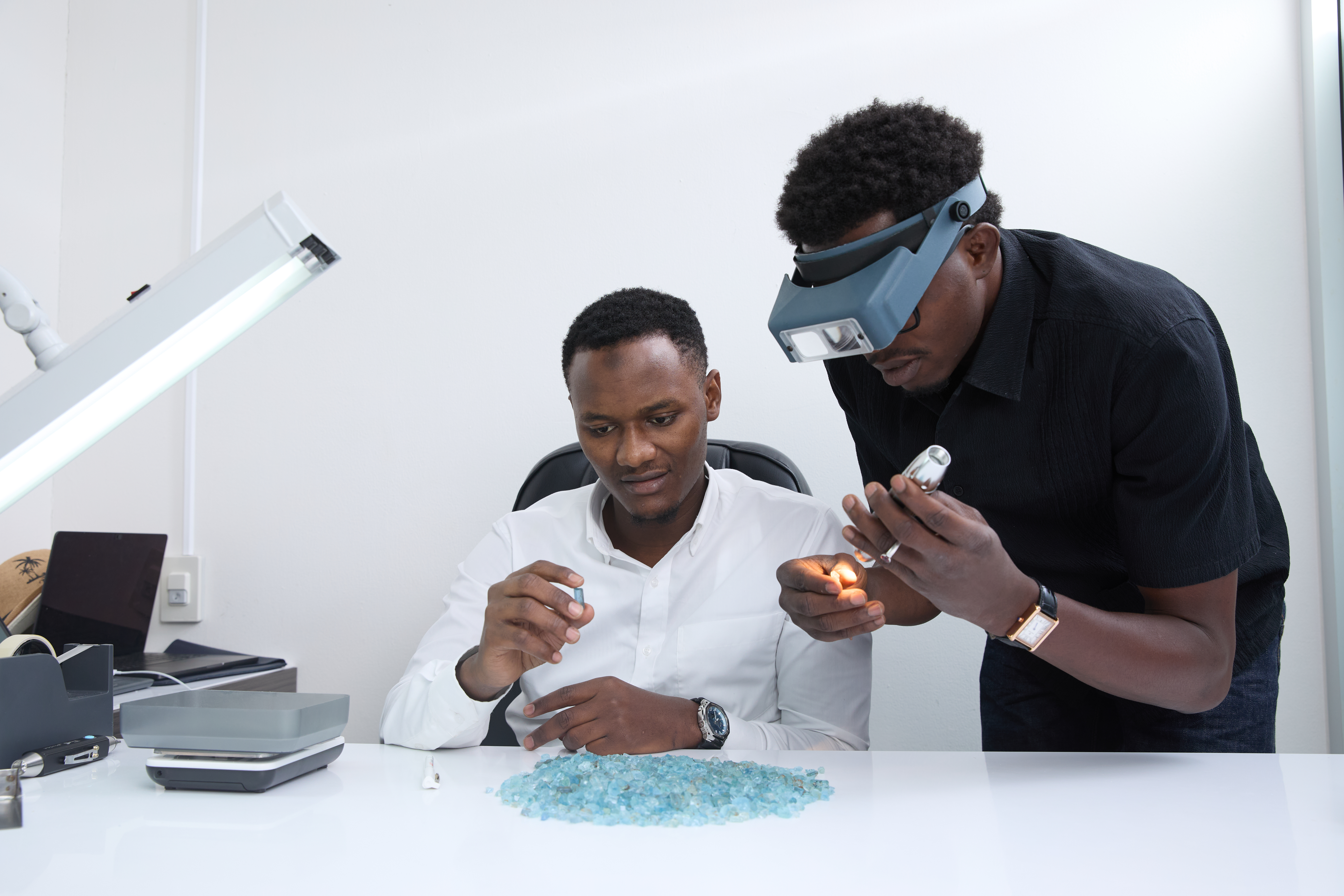 Africa Gem Finds team inspecting rough aquamarine